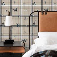 Tan kids wallpaper with navy alphabet letters and safari animal illustrations