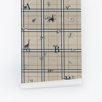 Tan plaid wallpaper with alphabet letters and animal illustrations for a nursery