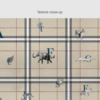 Tan plaid wallpaper with navy alphabet letters and safari animal icons