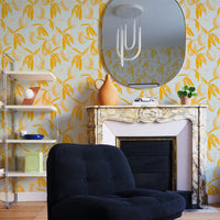 Yellow lemon print wallpaper with citrus branches and leaves on pale blue