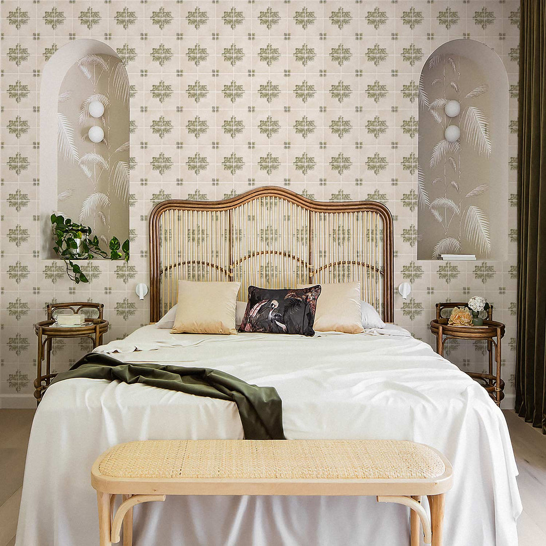Maximalist coastal style bedroom interior with palm leaf wallpaper as well as removable vintage Italian tile wallpaper accent wall behind rattan bed