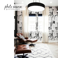 modern neutral living room interior with bold tropical wallpaper