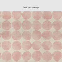 Pastel pink silk wallpaper close-up with soft watercolor polka dot pattern