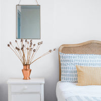 light blue coastal interior with fabric printed pillow