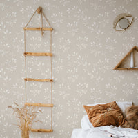 Boho girl's bedroom interior with mustard color decor and neutral color floral wallpaper