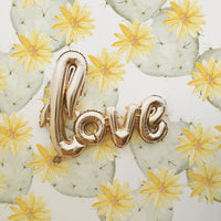 Bright yellow removable wallpaper with watercolor cactus print in heart shape and gold interior decor