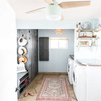 Coastal farmhouse design mudroom interior with cane pattern wallpaper