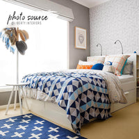 bright boys room interior with striped cube pattern wallpaper