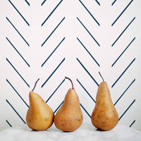 Navy blue herringbone design removable wallpaper in coastal kitchen interior with marble countertop