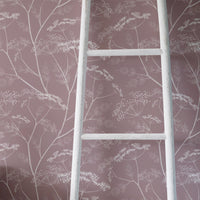 Vintage shabby chic style girl's room interior with dusty pink floral wallpaper