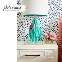 eclectic bohemian girls bedroom interior with navy tiny spots print wallpaper