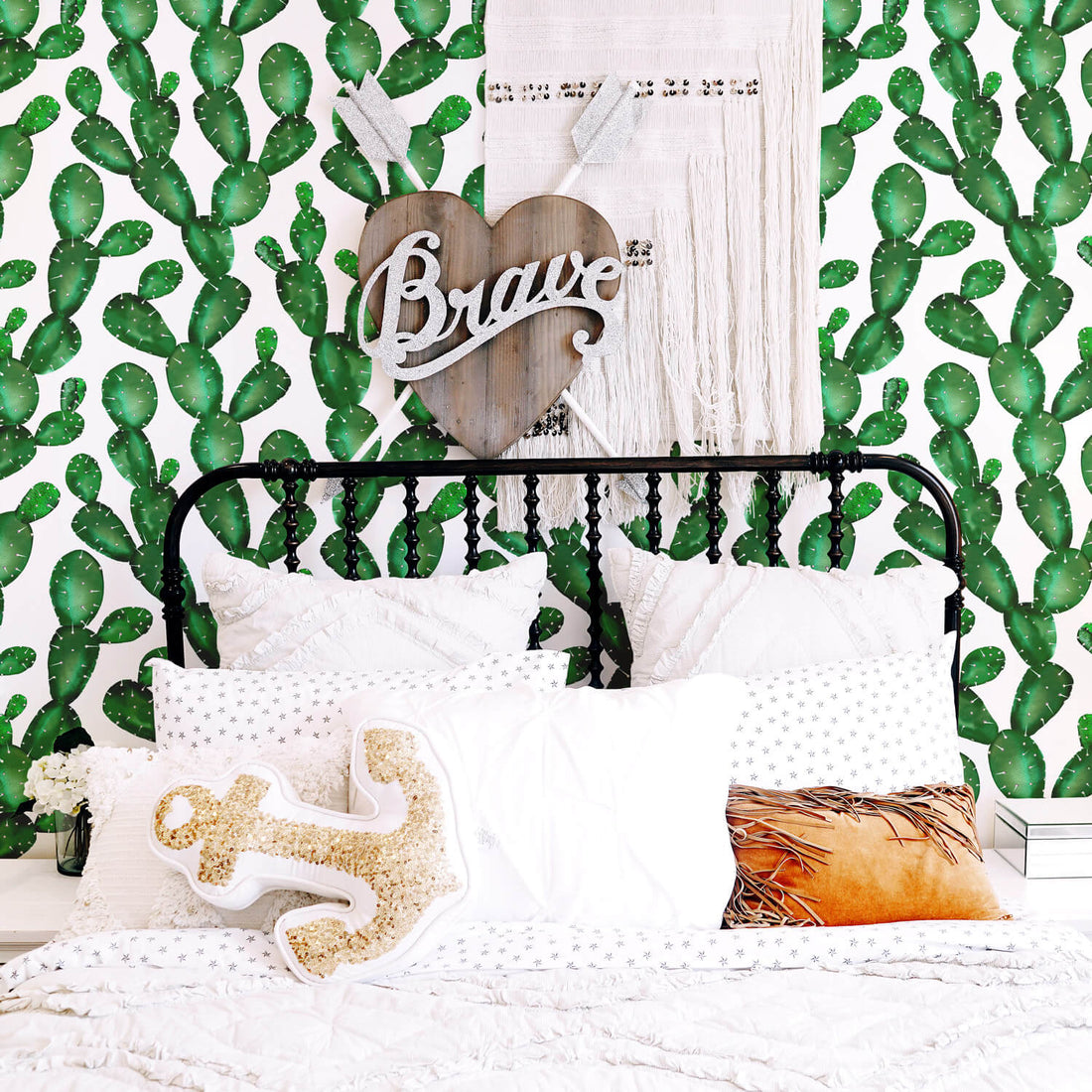 Watercolor cactus removable wallpaper in eclectic boho girl's bedroom with black farmhouse style bed, woven wall hanging and texas inspired interior decor