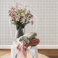 Grey watercolor gingham pattern removable wallpaper in bohemian interior with pink flowers and interior decor