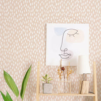 Pink spotty removable wallpaper in modern bohemian home office interior space