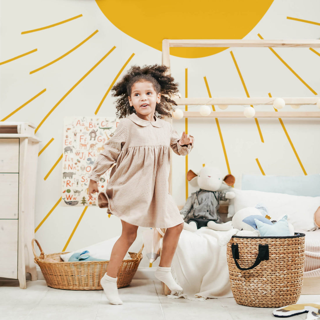 Whimsical sun design wallpaper in bohemian kids room interior