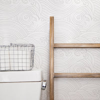 Coastal farmhouse style bathroom with wave design wallpaper