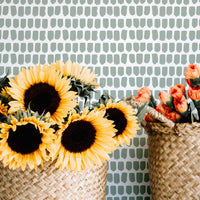 Sage green brush stroke design removable wallpaper in boho interior setting