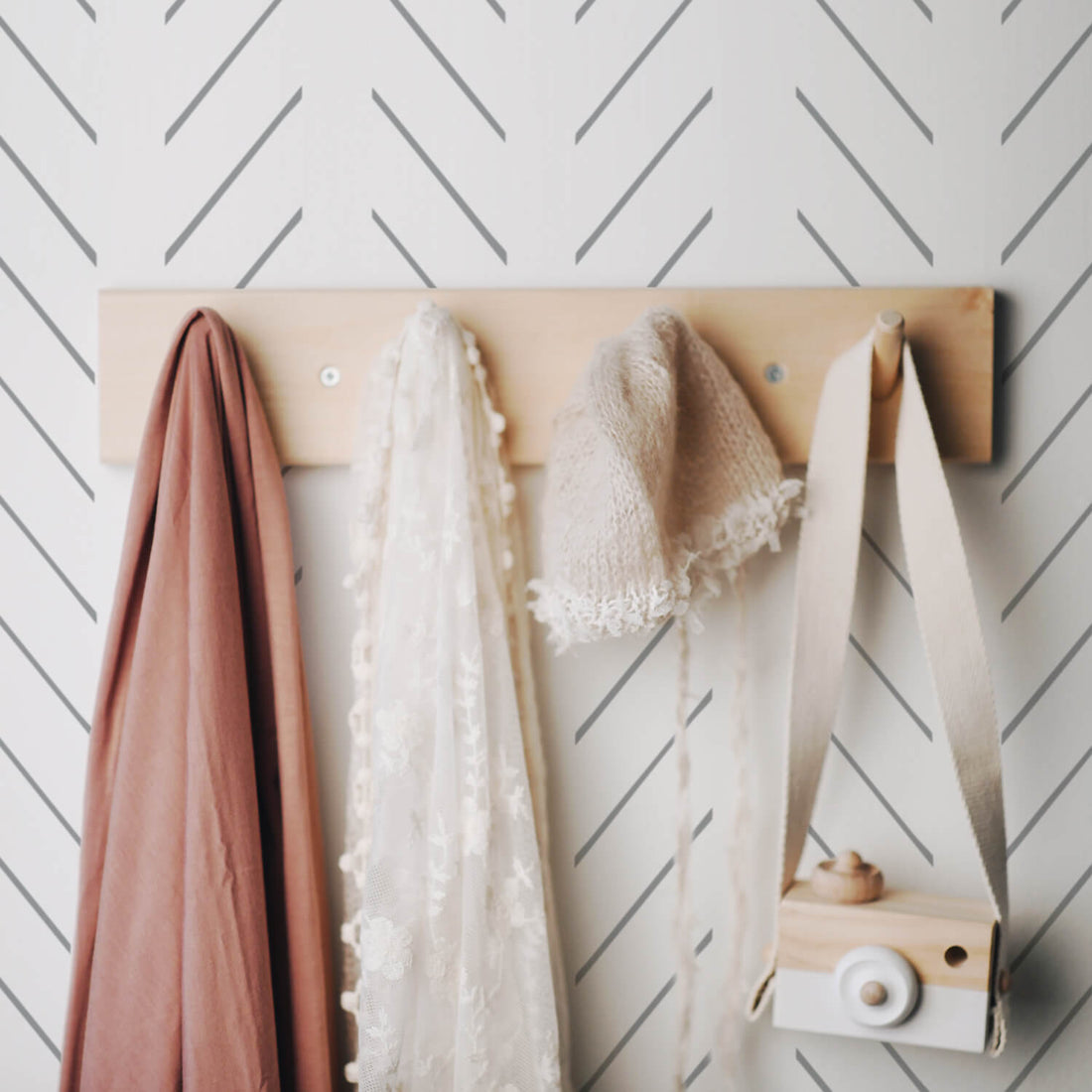 toddler girls bedroom interior with simple grey herringbone inspired wallpaper design