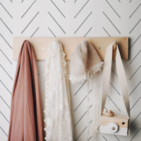 toddler girls bedroom interior with simple grey herringbone inspired wallpaper design