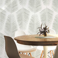 green palm leaves wallpaper in white chairs dining room setting