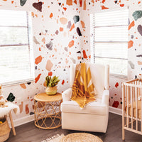Bohemian nursery interior with oversized terrazzo design wall mural