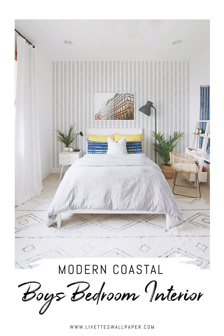 Modern coastal boys bedroom interior with white walls, scandi boho removable wallpaper feature wall and colorful room decor.