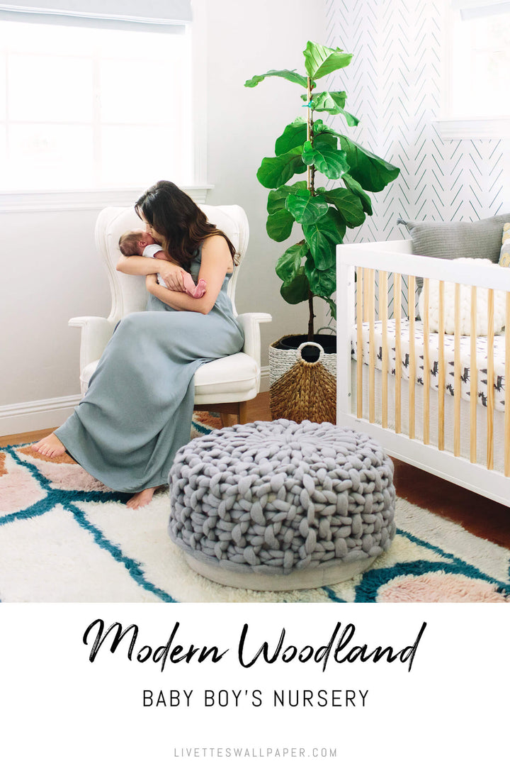 Modern woodland nursery with colorful baby room decor and black and white removable wallpaper.