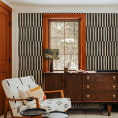 Black and cream grasscloth wallpaper with a minimal broken line grid