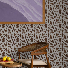 Pale grey wallpaper with a tiny brown watercolor cow print pattern