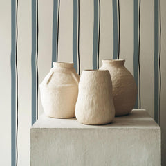 Cream wallpaper with blue and black hand-drawn vertical stripes