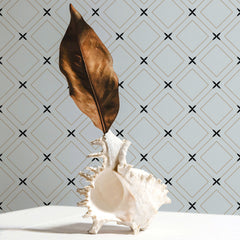 Blue-gray wallpaper with a gold diamond trellis outline and black X accent pattern