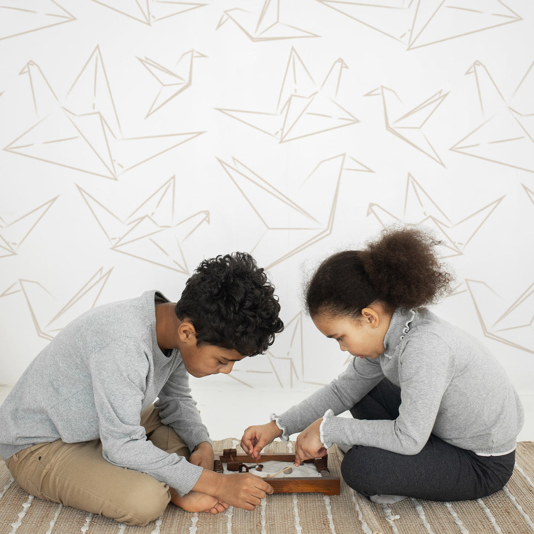 Minimal origami crane design removable wallpaper in scandinavian kids playroom interior
