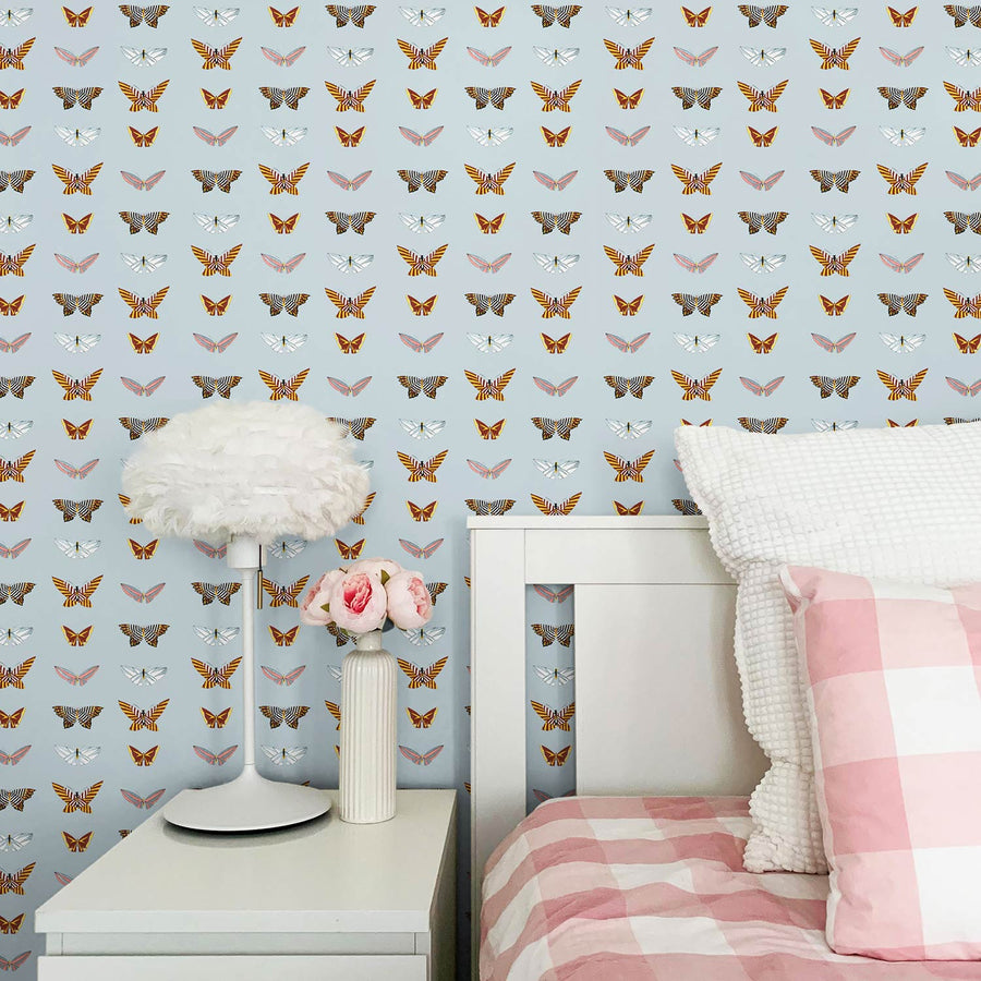 Classic colorful girls bedroom interior with blue vintage butterfly wallpaper