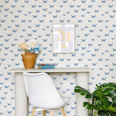 White wallpaper with repeating blue dog silhouette pattern