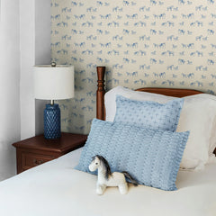 Cream kids wallpaper with small scattered blue horse silhouettes