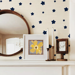 Cream grasscloth wallpaper with tiny navy blue flowers scattered throughout