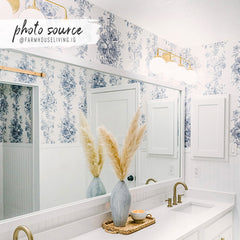Blue and white toile bathroom wallpaper with a vintage floral pattern