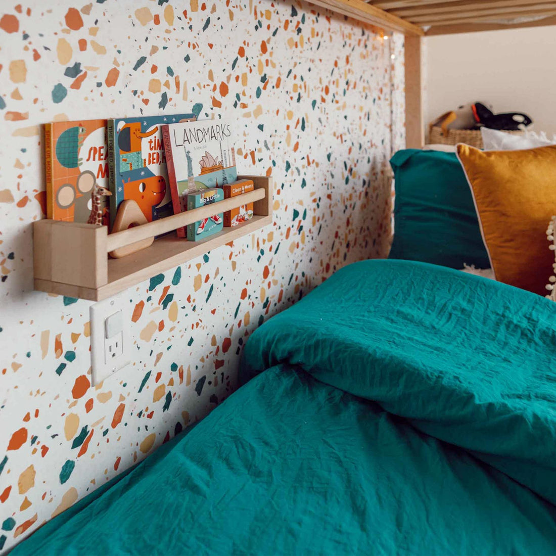 bold colors terrazzo print wallpaper design for kids bedroom with bookcase