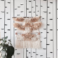 Modern birch tree wallpaper with beautiful blush pink wall hanging in girl's bedroom interior