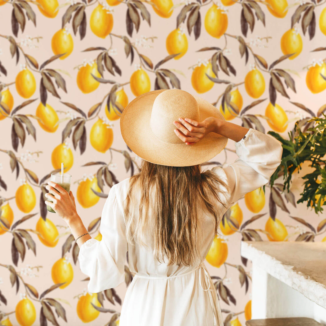 Modern bohemian interior with light pink removable wallpaper with yellow lemons and flowers