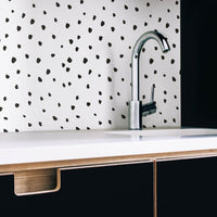 Minimalistic kitchen interior with removable wallpaper as backsplash