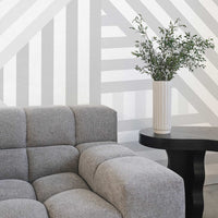 light grey interior design with textured sofa and geometric shaped wall mural
