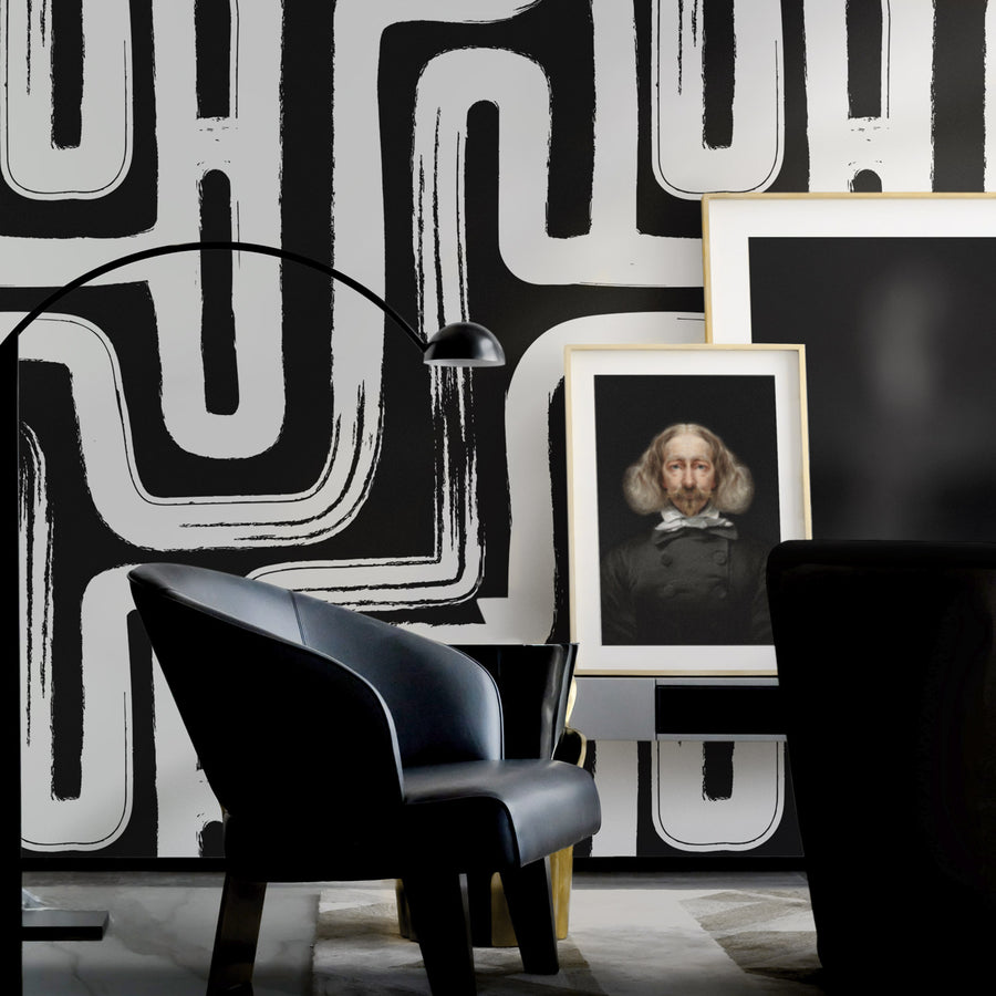 Moody interior setting with oversized black and white paintbrush design removable wallpaper