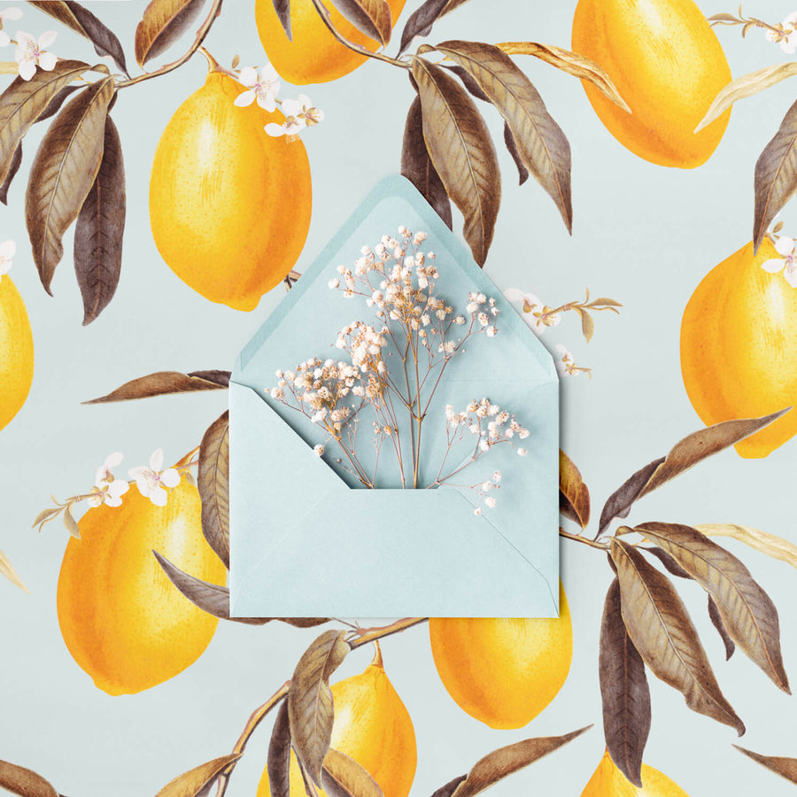 light blue botanical removable wallpaper with yellow lemons