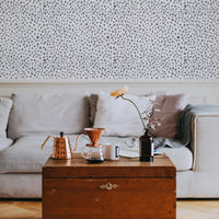 Grey dalmatian print removable wallpaper in neutral bohemian style living room interior