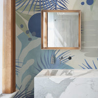 Abstract coastal wall mural wallpaper in chic minimal bathroom interior with marble sink