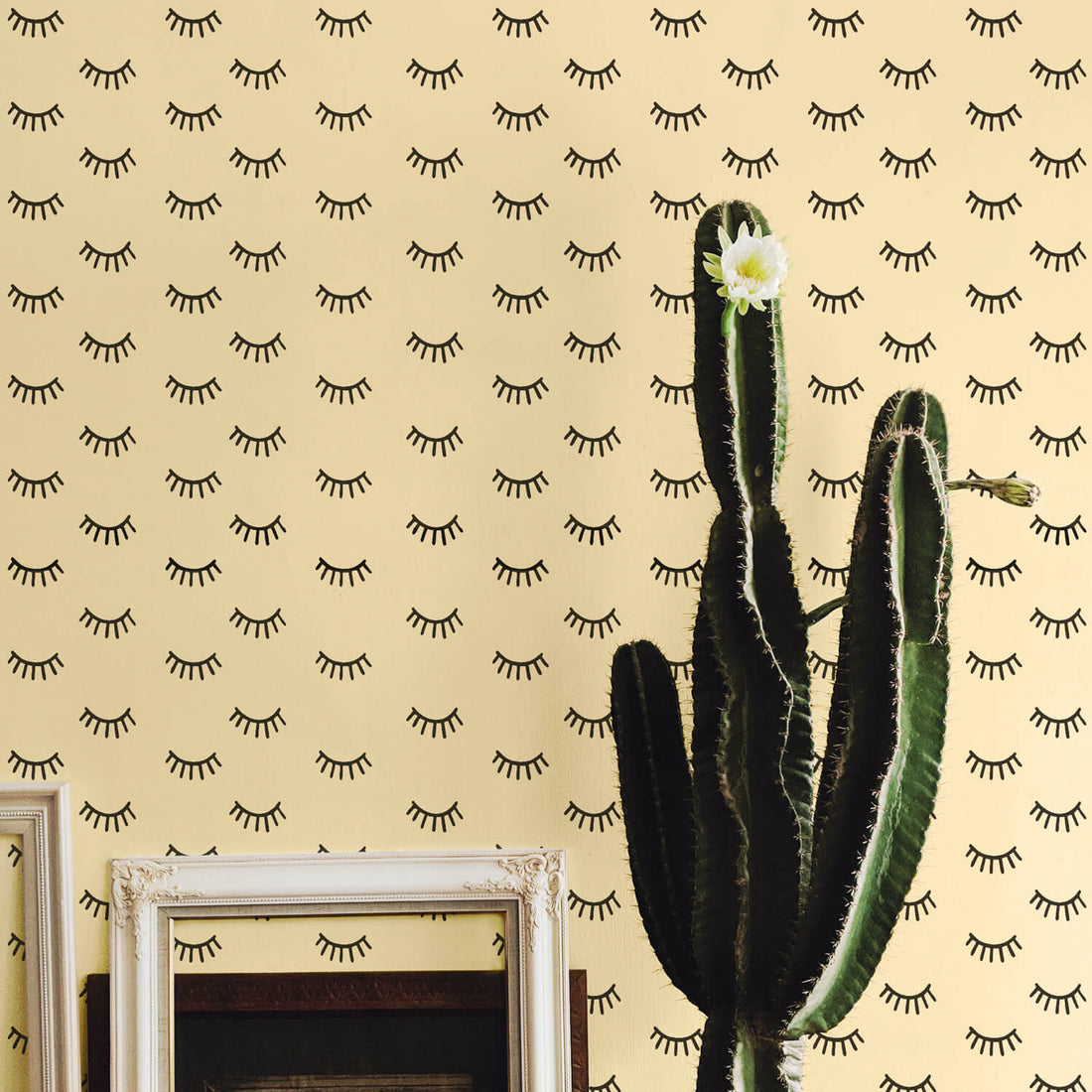 Boho girl's room interior with flowering cactus and sleepy eyes removable wallpaper in yellow and black color